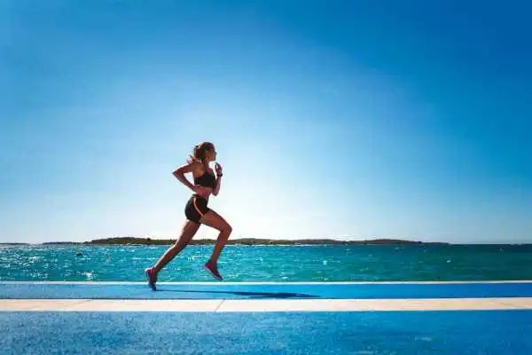 Woman running showing strong leg muscle Wrexham